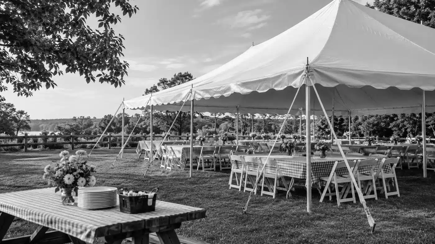 Outdoor event tent with empty tables and chairs