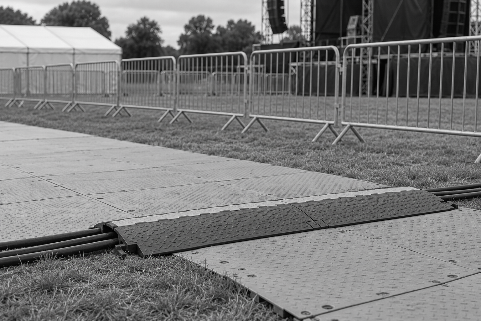 Temporary flooring with a cable protector and crowd barriers