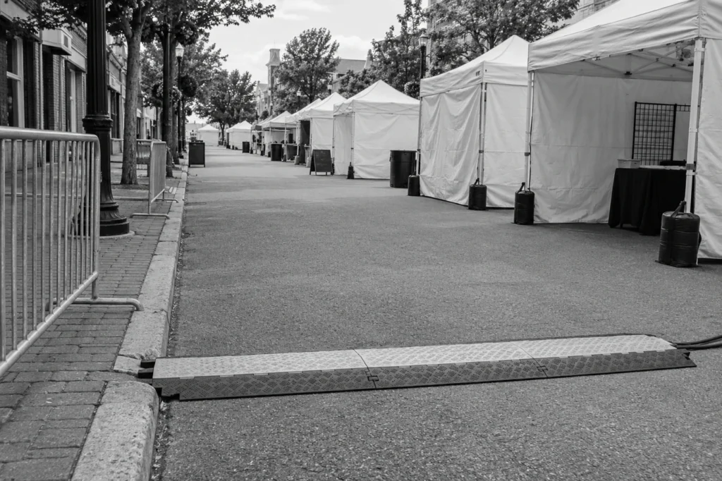 Empty street-fair walkway with a cable cover between vendor tents