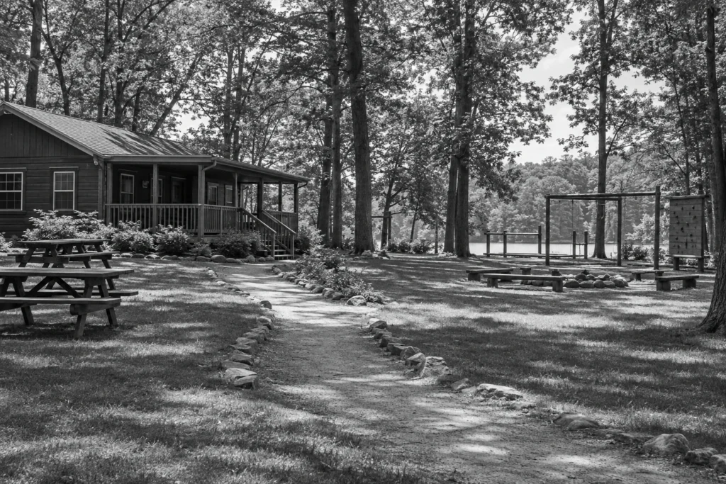 Empty summer-camp grounds with cabins and picnic tables