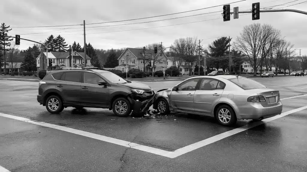 Two damaged cars at an intersection